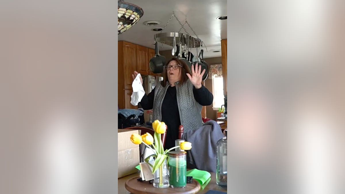 A woman reads a surprise pregnancy announcement.