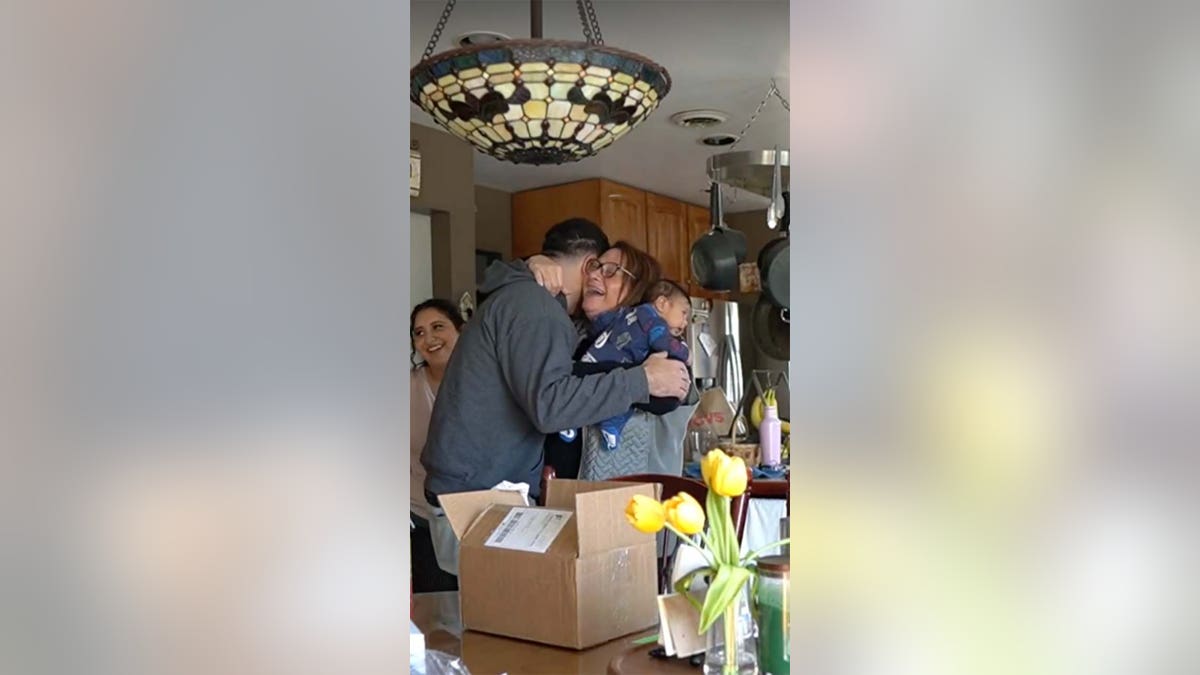 A woman hugs her son.