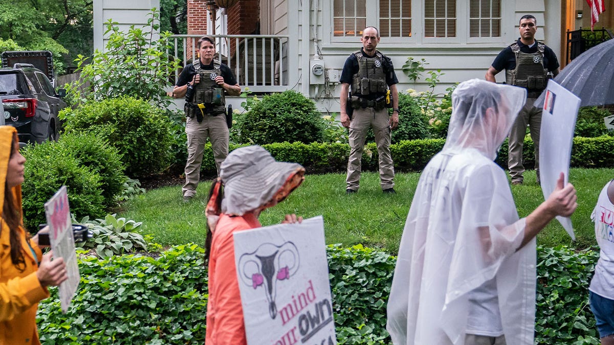 CHEVY CHASE, MD - Protesters march past Supreme Court Justice Brett Kavanaughs home on June 8, 2022 in Chevy Chase, Maryland. An armed man was arrested near Kavanaughs home.