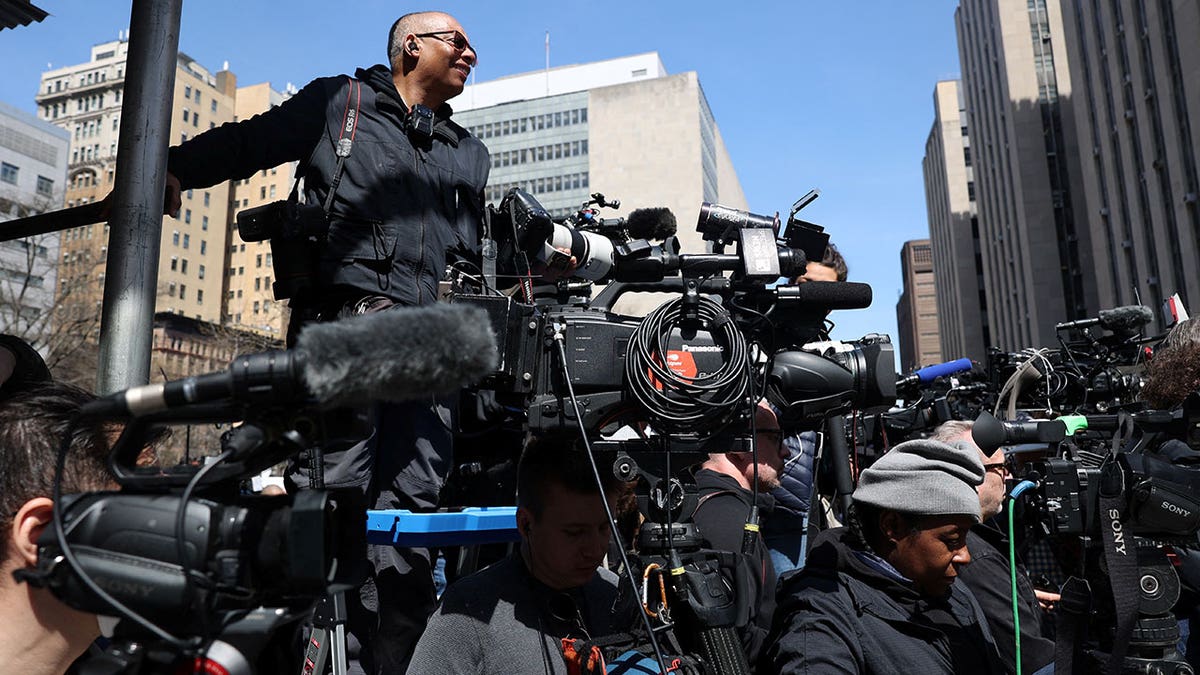 Members of the media gather outside Manhattan Criminal Courthouse on the day of former U.S. President Donald Trump's court appearance after his indictment by a Manhattan grand jury following a probe into hush money paid to porn star Stormy Daniels, in New York City, U.S., April 4, 2023. REUTERS/Caitlin Ochs