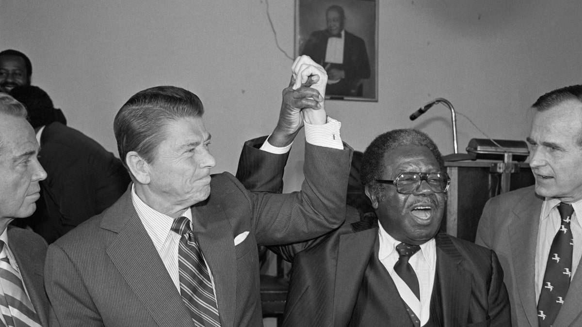 Then-Republican presidential candidate Ronald Reagan joins hands with civil right leader Ralph Abernathy following his surprise endorsement of the former film star and California governor in 1980.