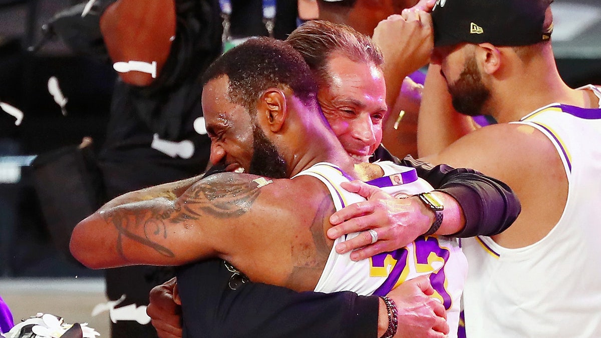 LeBron James hugs general manager Rob Pelinka