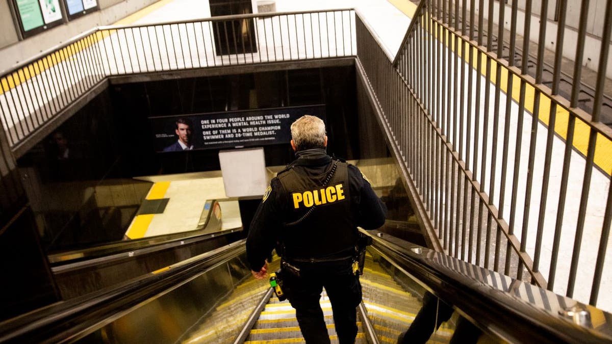 BART police officer descending into subway