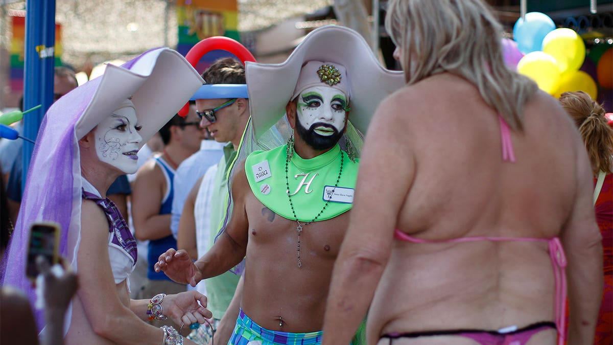 WEST HOLLYWOOD, CA - JUNE 09: Members of the Sisters of Perpetual Indulgence, who dress as "queer nuns," talk to a man at the 43rd L.A. Pride Parade on June 9, 2013 in West Hollywood, California. More than 400,000 people are expected to attend the parade in support of lesbian, gay, bisexual and transgender communities. (Photo by David McNew/Getty Images)