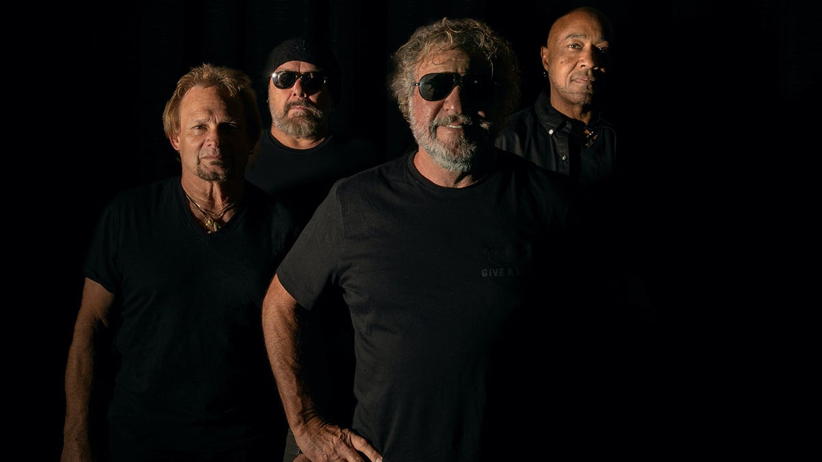 Sammy Hagar posing with his band members from The Circle