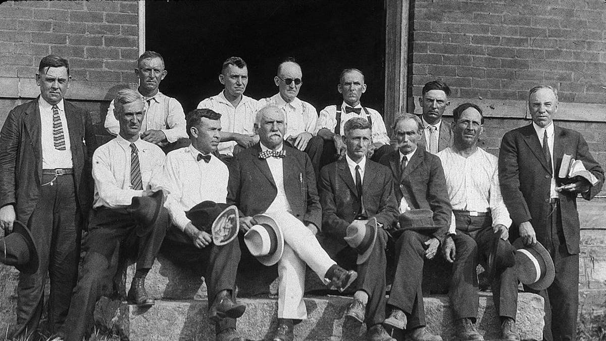 FILE – The jury and Judge John T. Raulston (standing at far right) on the steps of a building during the 'Scopes Monkey Trial' in which school teacher John Scopes was prosecuted for teaching the theory of evolution in violation of Tennessee's Butler Act, Dayton, Tennessee, July 1925. (Photo by /Getty Images)