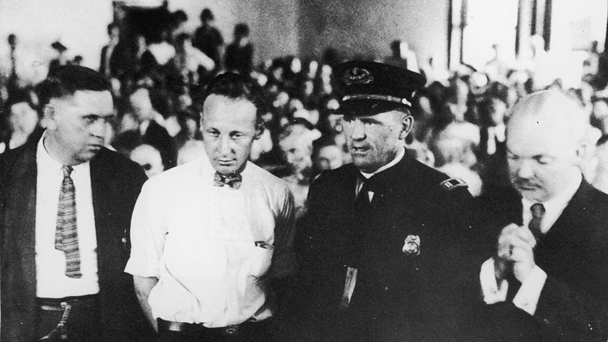 FILE – 1925: ?American teacher John Thomas Scopes (1900 - 1970) (2nd from L) standing in the courtroom during his trial for teaching Darwin's Theory of Evolution in his high school science class, Dayton, Tennessee. Scopes's case came to be known nationwide as the 'Scopes Monkey Trial.' ?(Photo by Hulton Archive/Getty Images)