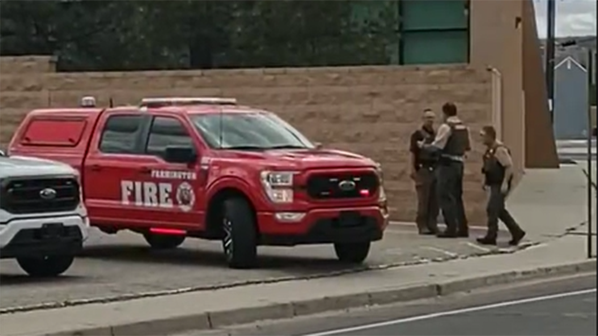 Cops and fireman outside at a crimescene