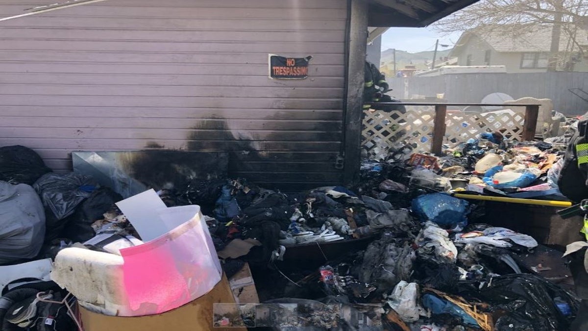 debris outside burnt out squatter house