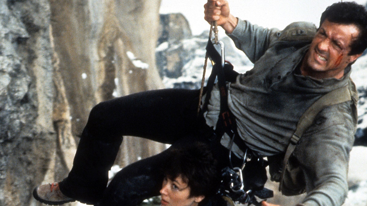 Sylvester Stallone rapelling down a cliff in "Cliffhanger"