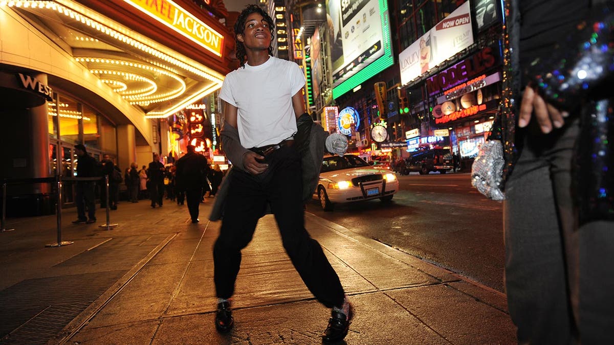 Two Michael Jackson impersonators on the street in at night