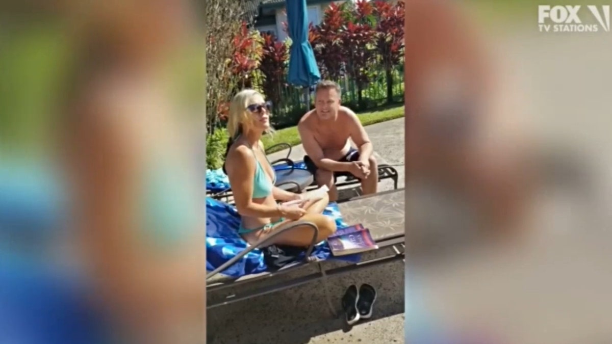 Lori Vallow sitting poolside in a blue bikini next to Chad Daybell