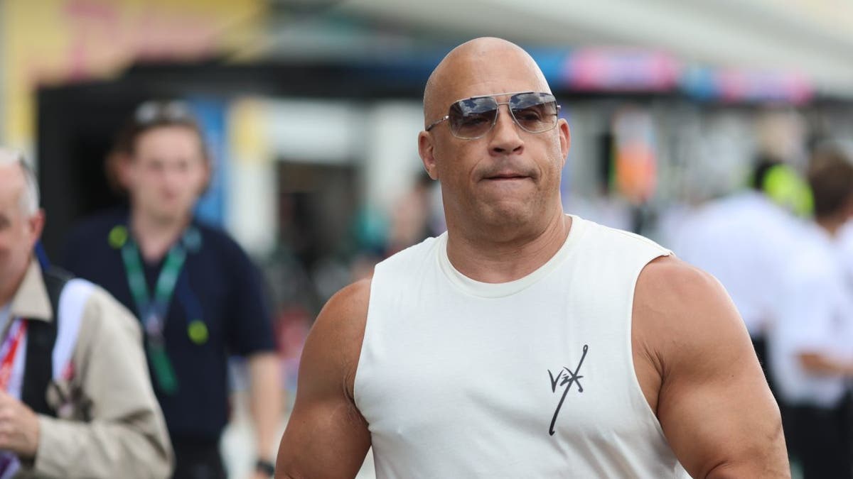 Fast and Furious star Vin Diesel wore a white shirt and sunglasses at F1 race