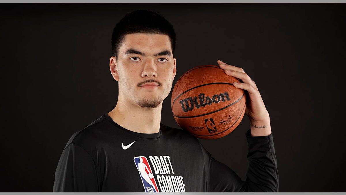 Zach Edey poses with basketball