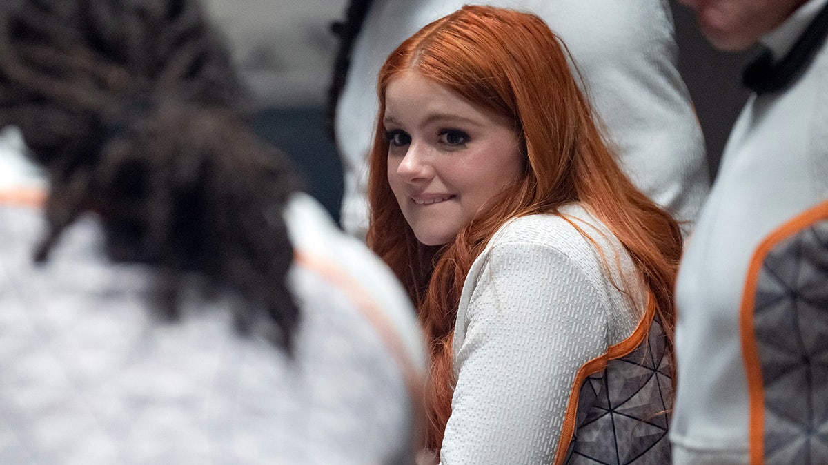 Ariel Winter shows off red hair while wearing white jumpsuit