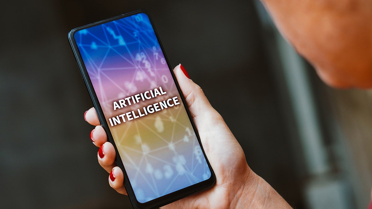 The words artificial intelligence on a phone screen