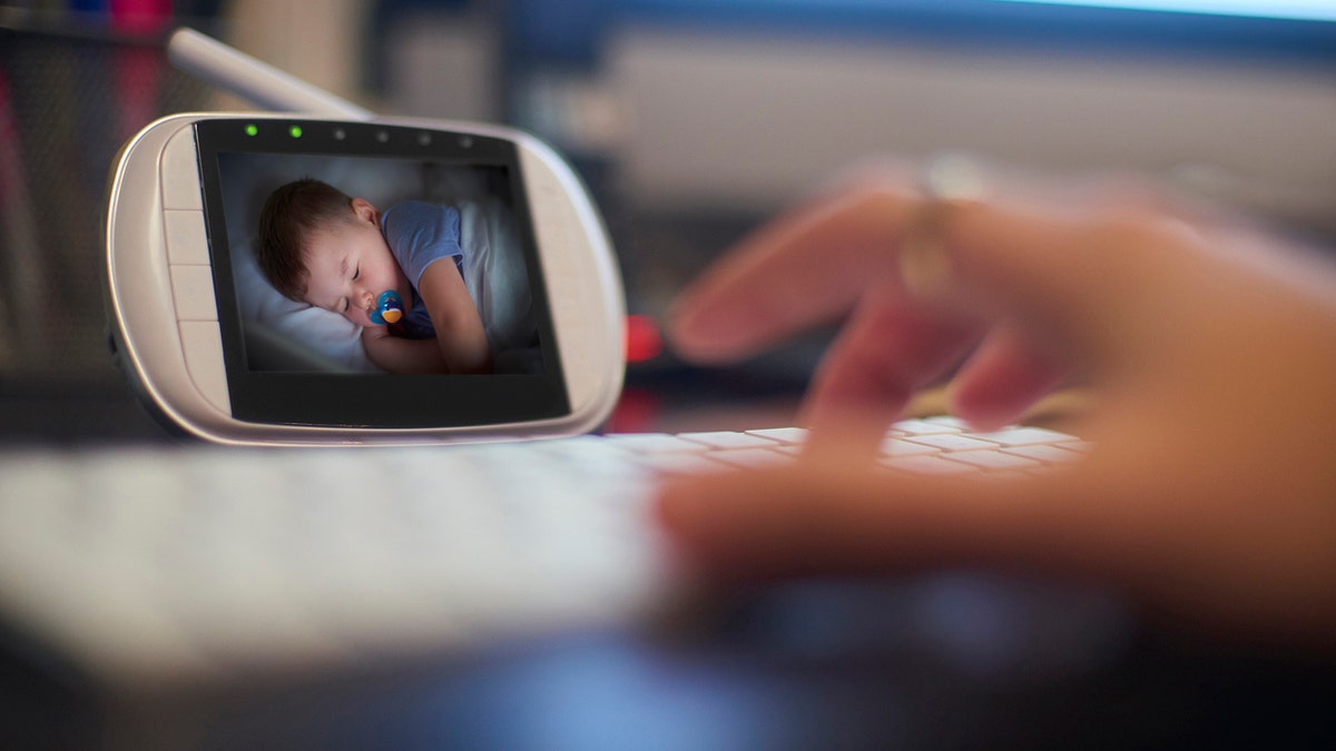 parent watches child on baby monitor 