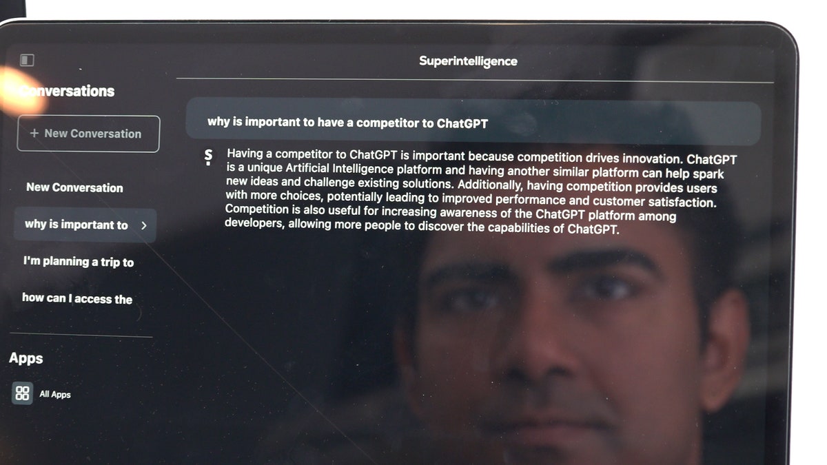 AI developer Arvin Bhangu's face reflects off of his iPad while he searches his app Superintelligence