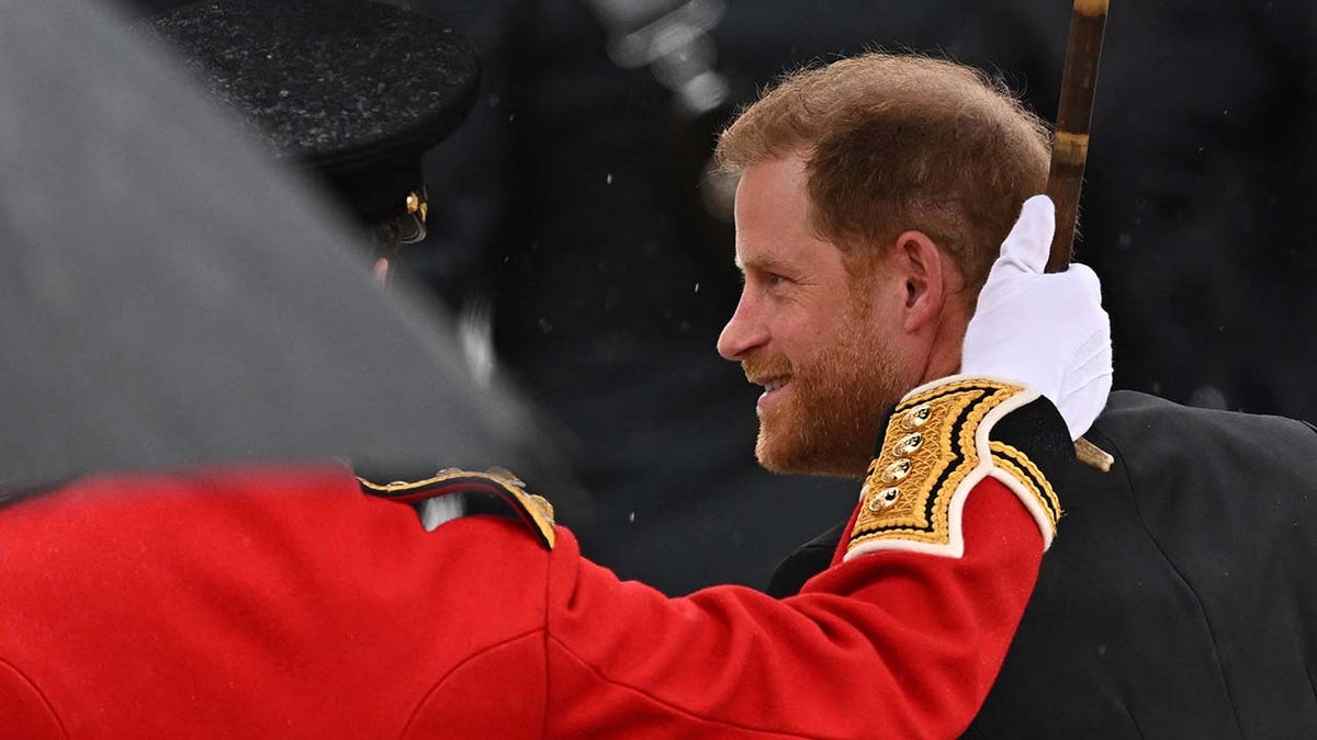 Prince Harry, Duke of Sussex, walks outside Westminster Abbey ahead of Britain's King Charles' coronation