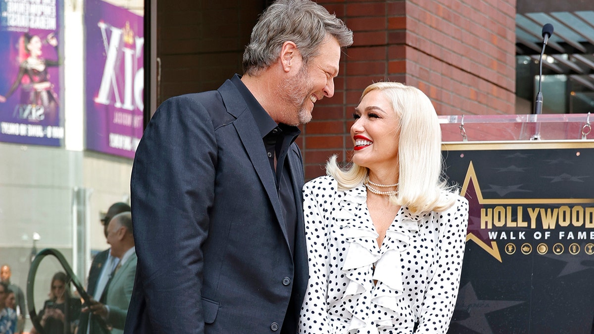 Blake Shelton and Gwen Stefani looking lovingly at each other at the Hollywood Walk of Fame