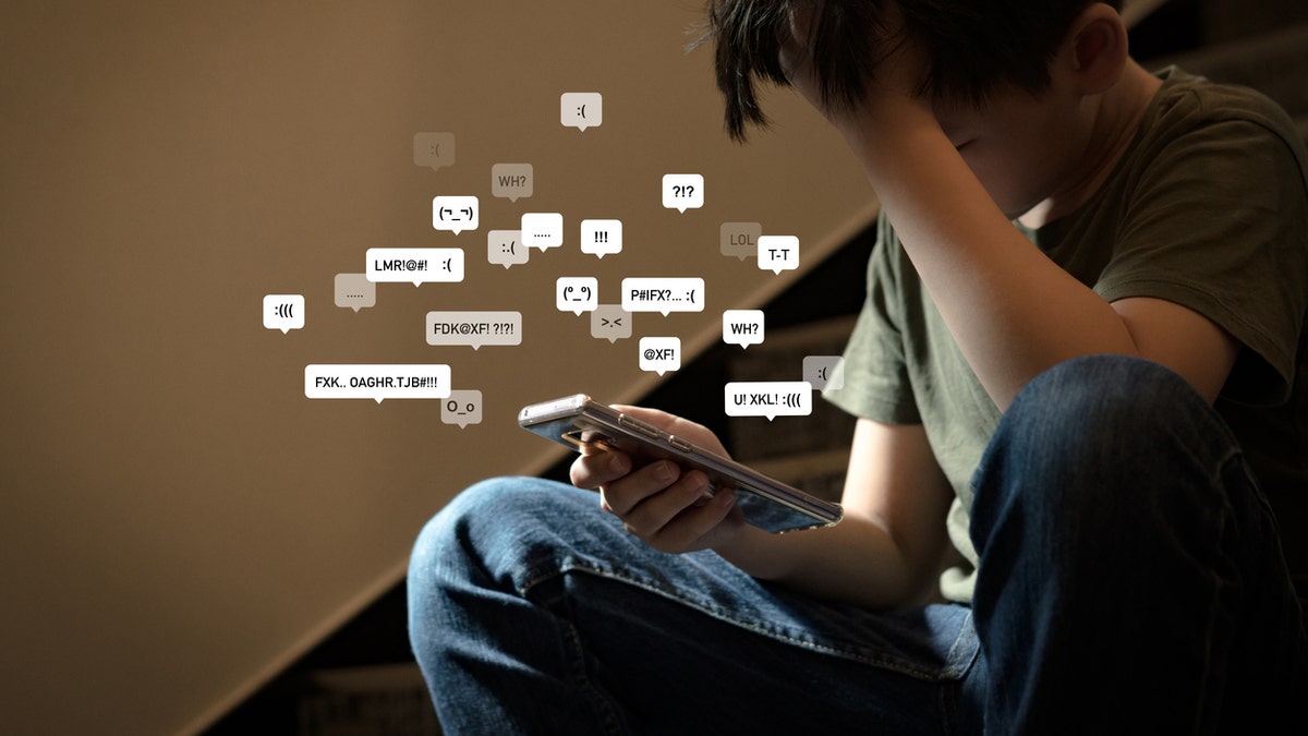 Boy on phone - cyberbullying