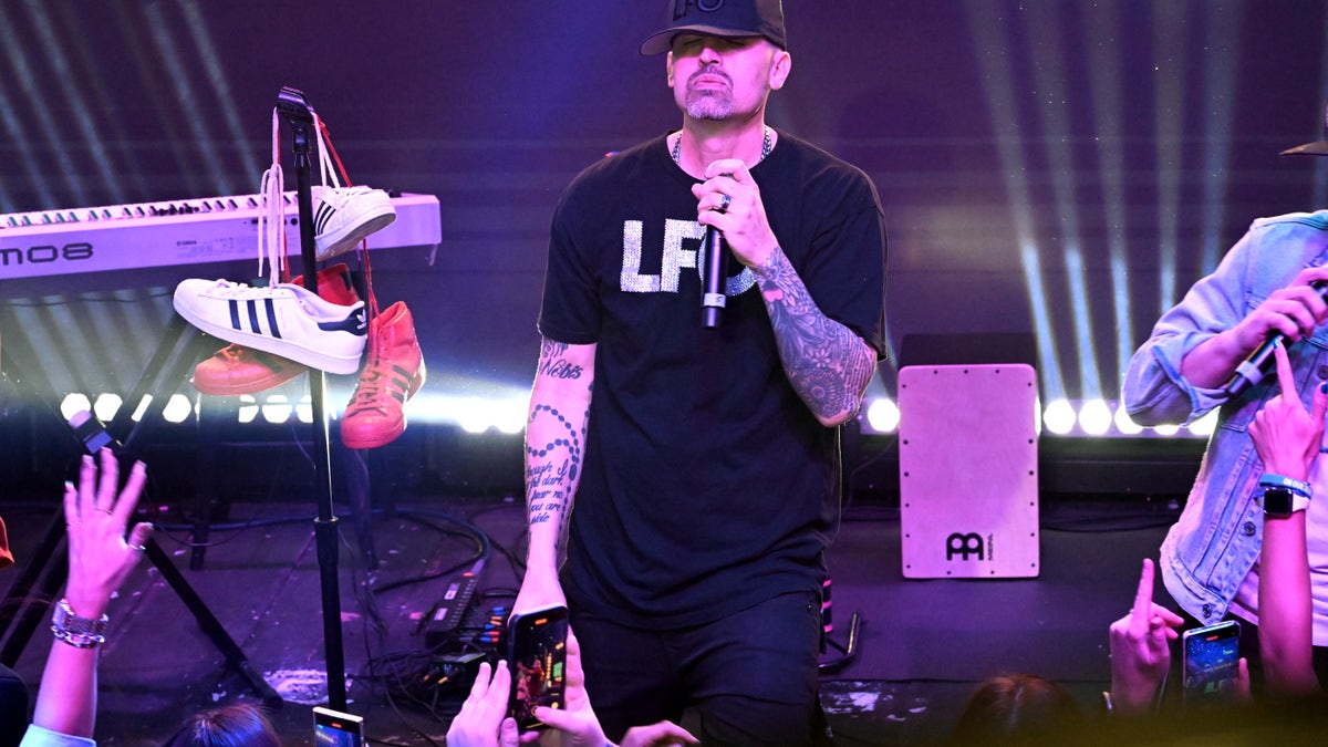 Brad Fischetti stands onstage during a concert.