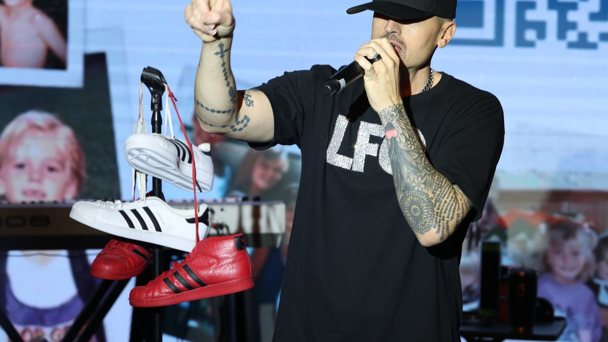 Brad Fischetti speaks into a microphone during a concert.