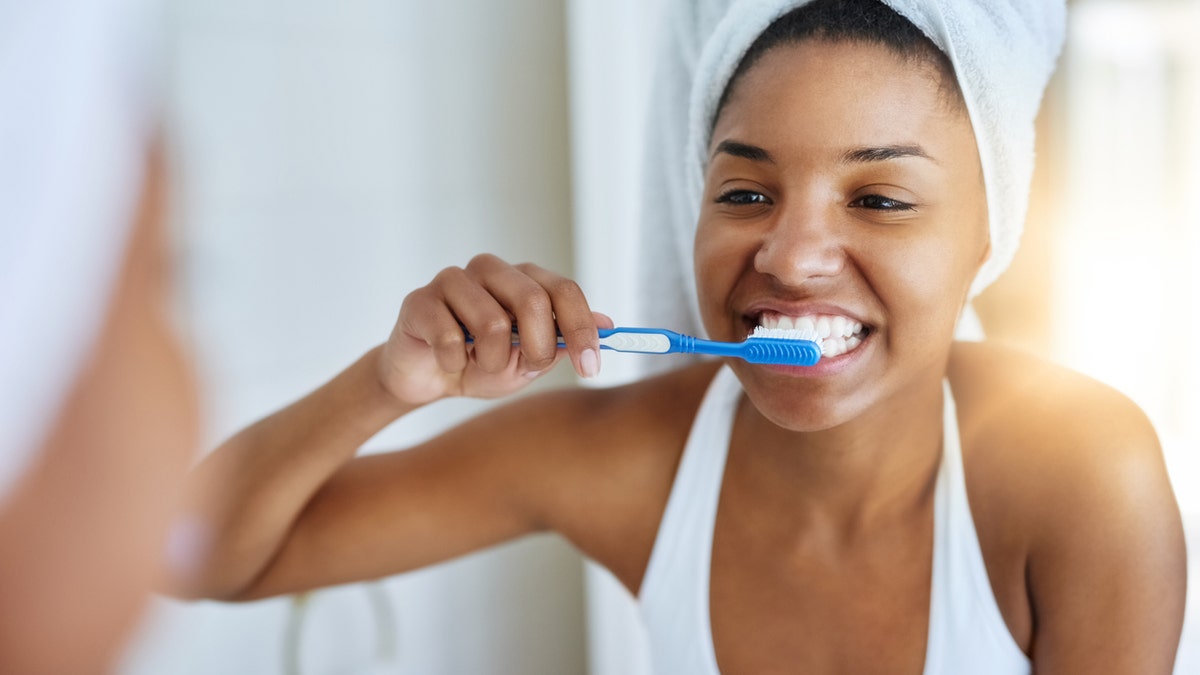 Woman brushing teeth