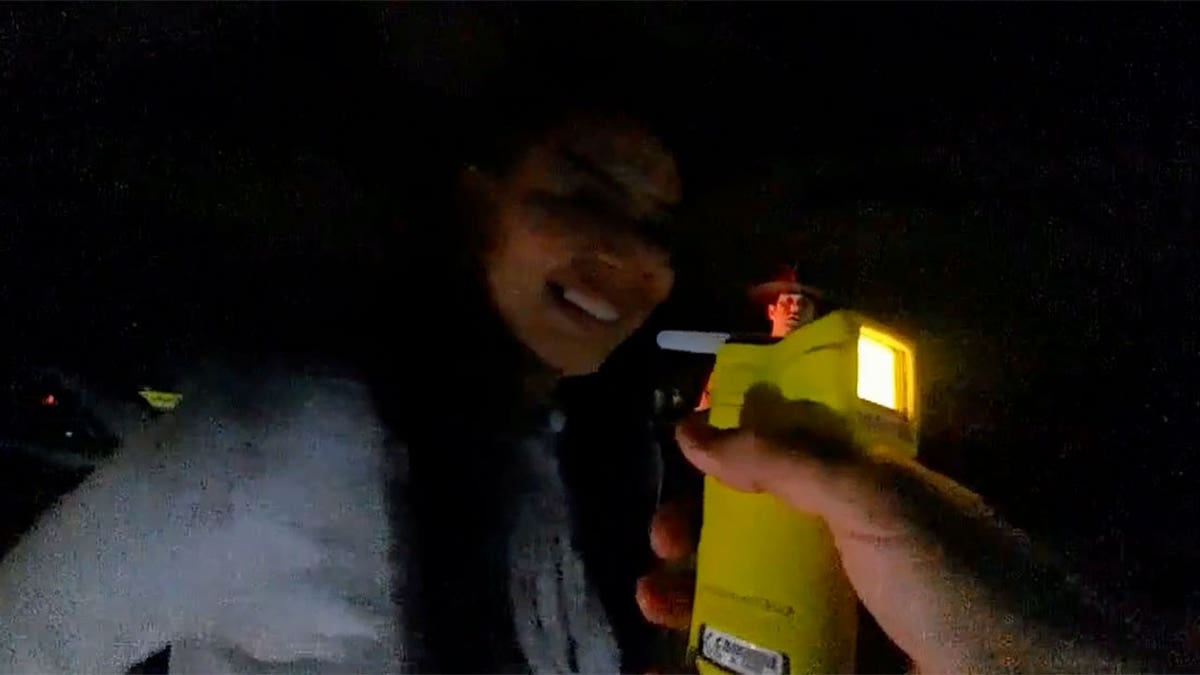 Stephanie Melgoza shown about to blow into a breathalyzer during a field sobriety test.