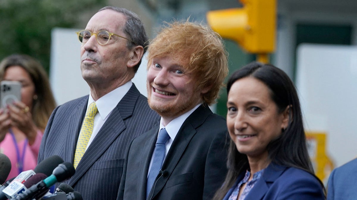 Ed Sheeran wears black suit with blue tie at Manhattan courthouse