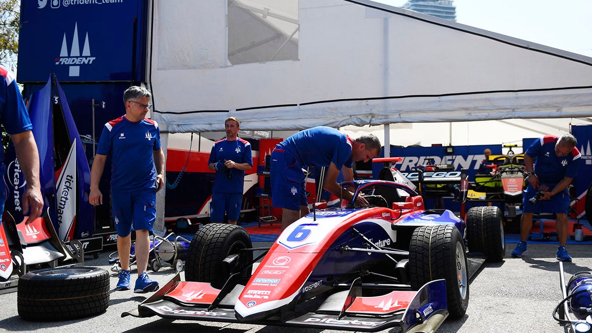 Team members working on car