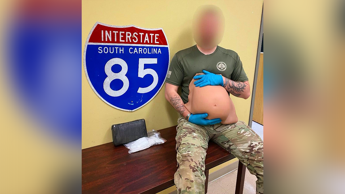 Deputy holds fake pregnancy belly