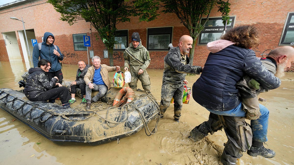People are rescued in Faenza, Italy, on May 18, 2023. Exceptional rains in a drought-struck region of northern Italy have killed at least nine people. Rescue teams began working to reach isolated towns cut off from the flooding.