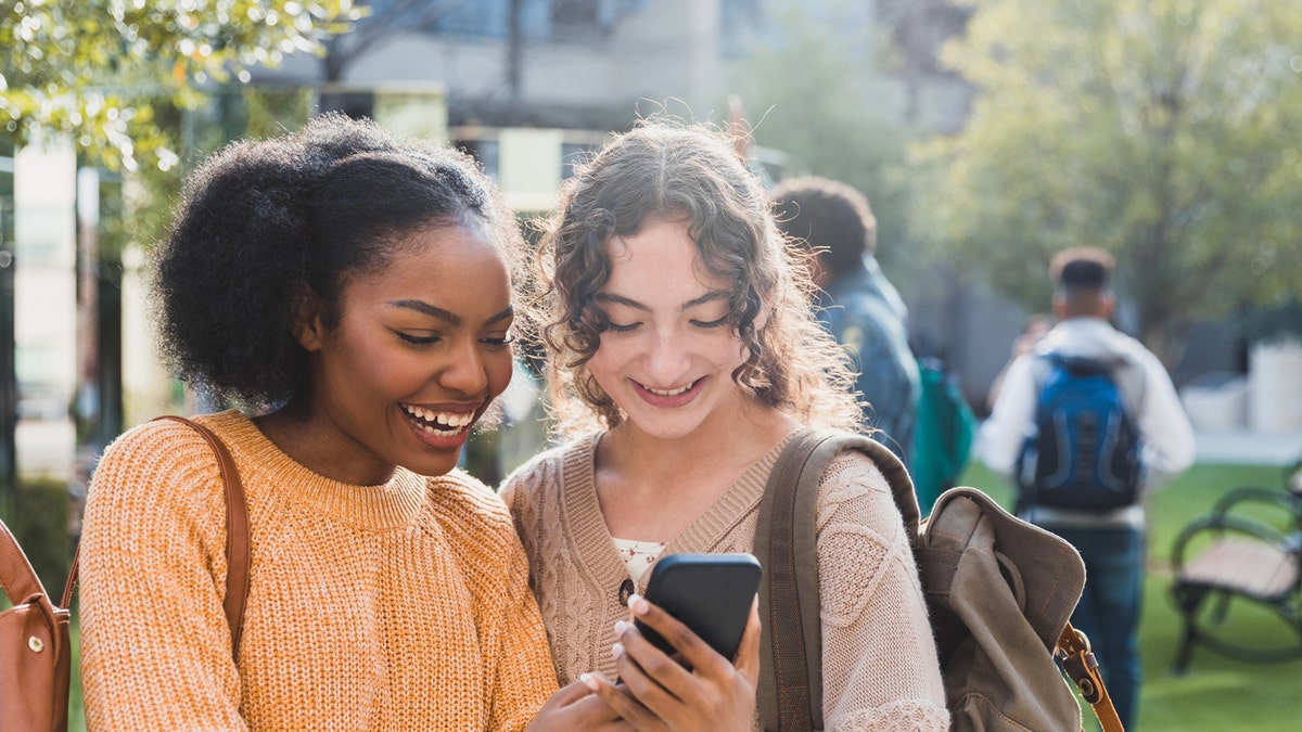 Girls smiling on phone