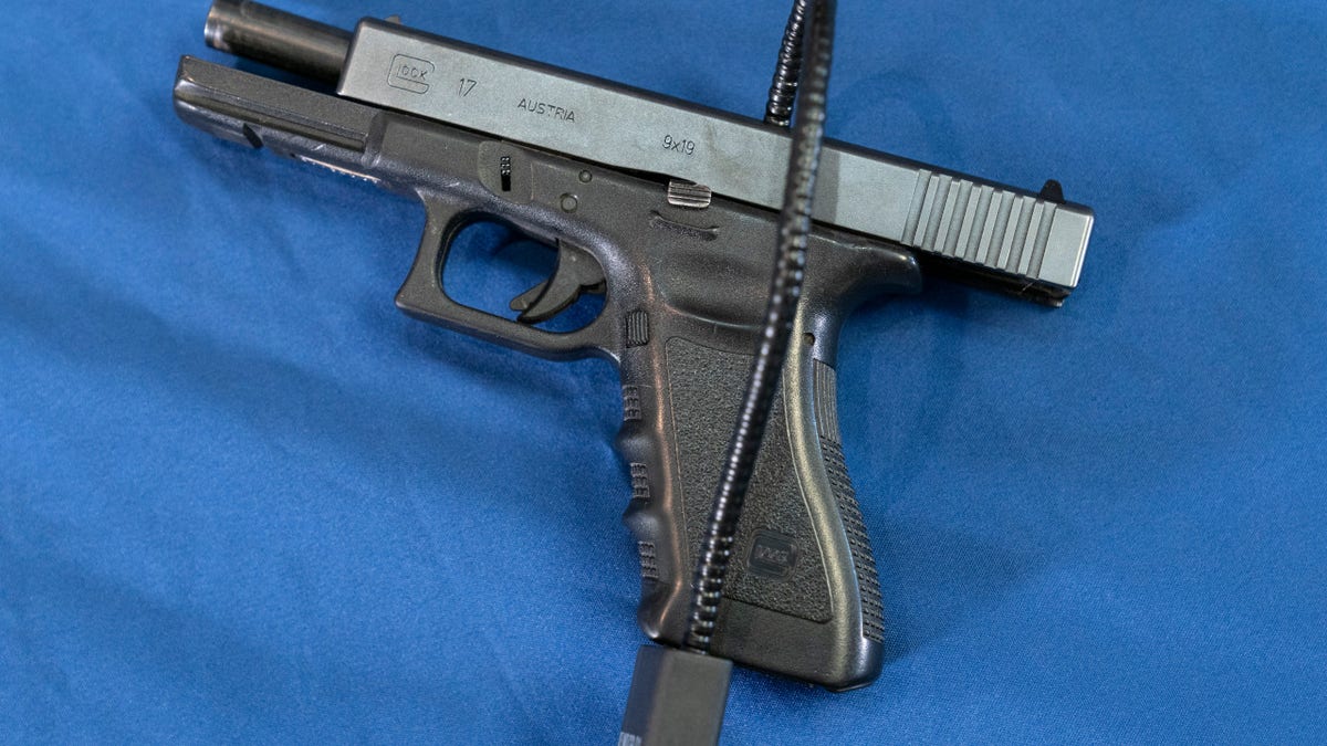 Displayed is a Glock 17 pistol fitted a with a cable style gun lock in Philadelphia, Wednesday, May 10, 2023.