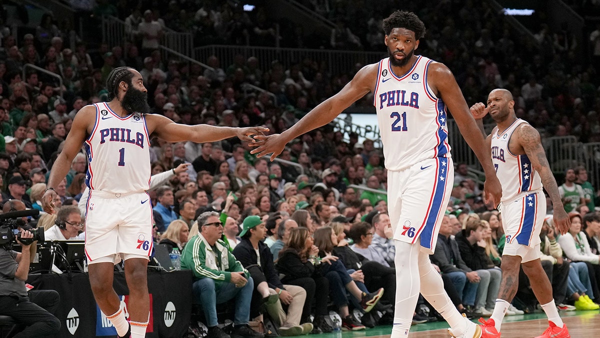 James Harden #1 of the Philadelphia 76ers high fives Joel Embiid #21