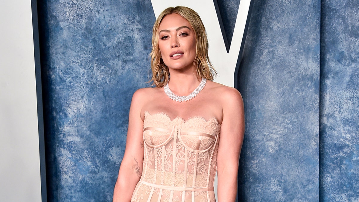 Hilary Duff rocks pink strapless lace dress at Oscars party