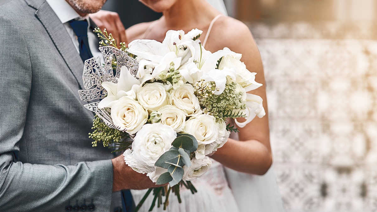bride and groom together with flowers
