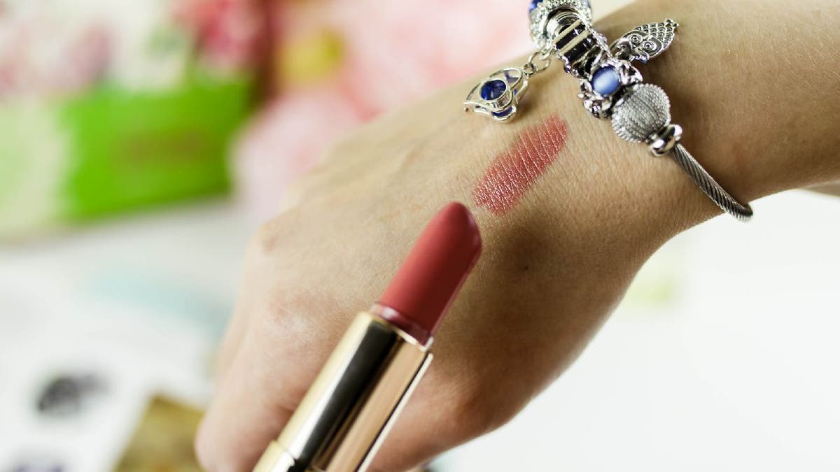 Lipstick swatch on hand.