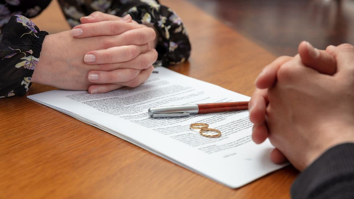 Divorce lawyer goes over paperwork with woman