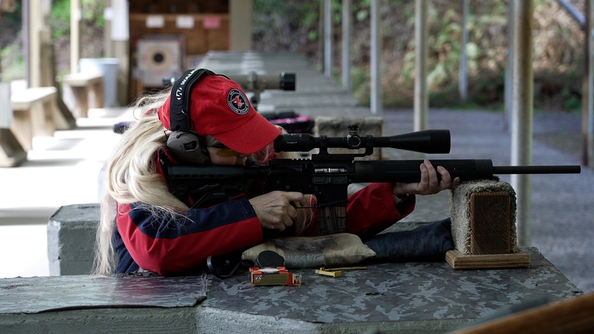 Firearms instructor Jane Milhans shoots a modern sporting rifle at a range in Washington state