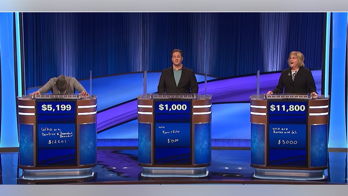 Three contestants in playing Jeopardy.