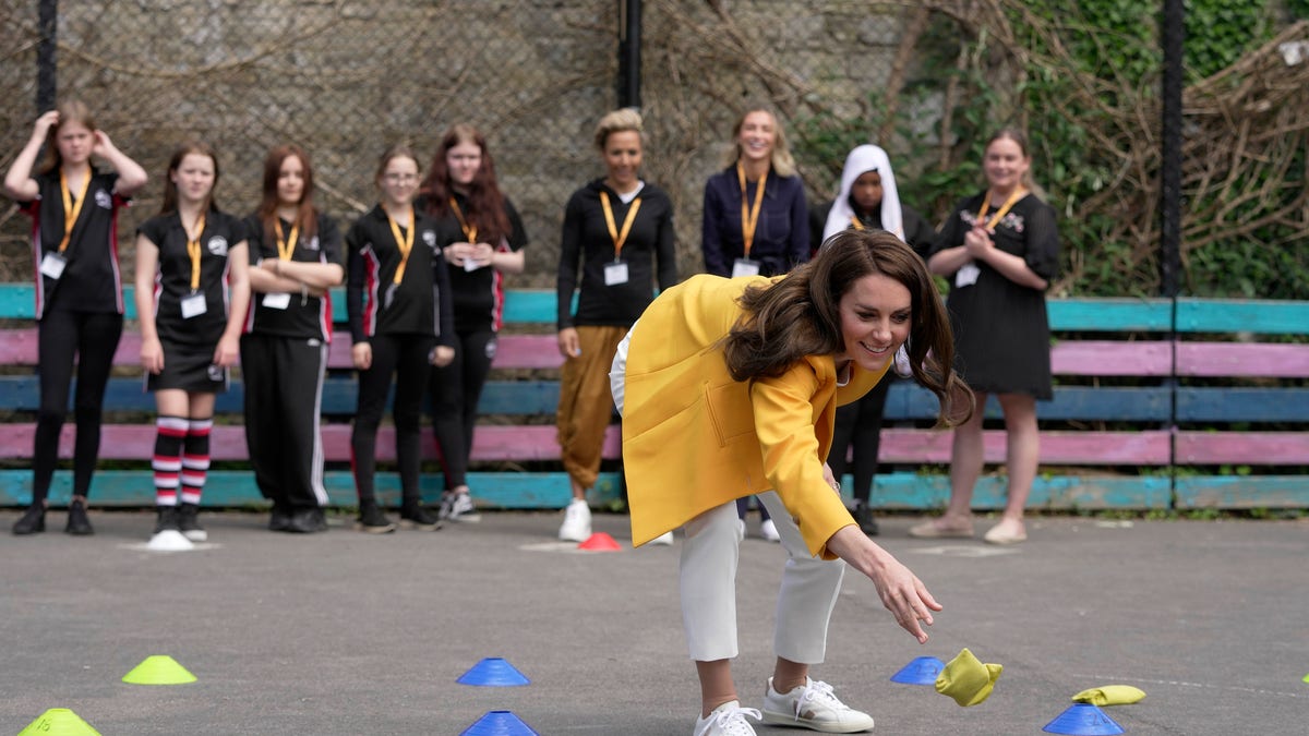 Kate Middleton playing a game with bean bags