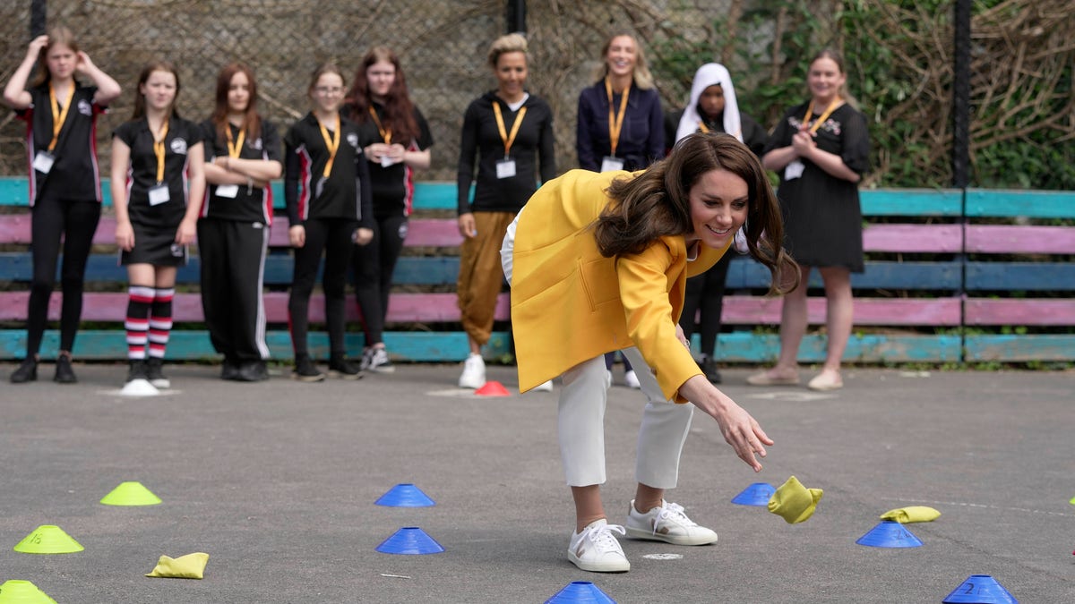 Kate Middleton playing a game with bean bags