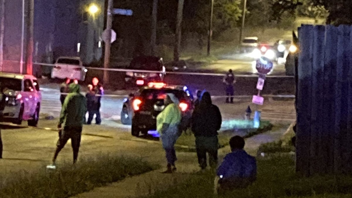 people on street near shooting scene