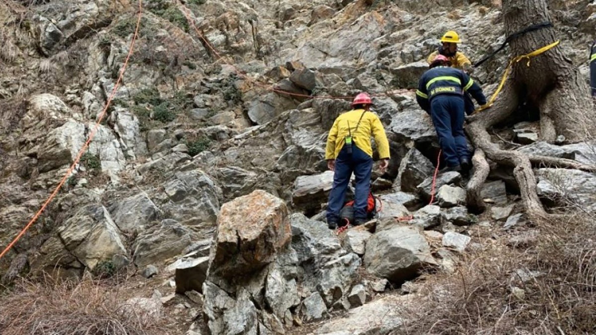 rescue personnel on rocks