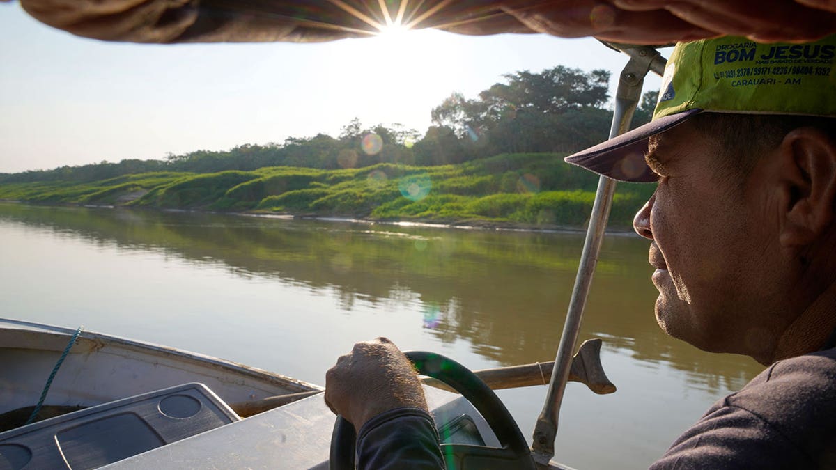 Man maneuvers boat in Brazil