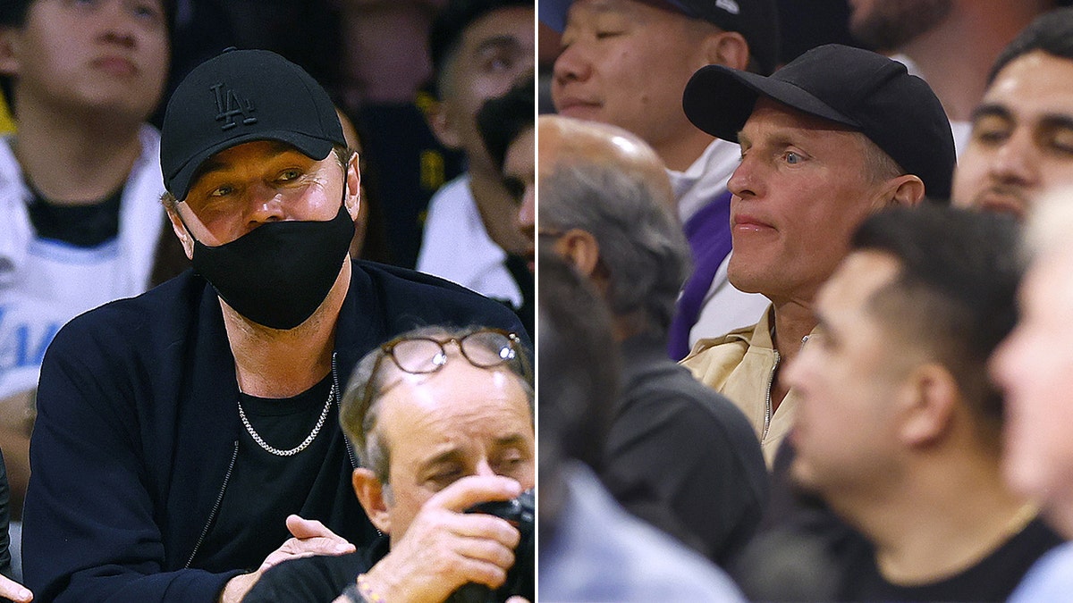 Leonardo DiCaprio sits behind a cameraman in wearing a black baseball hat and face mask watching the Lakers split Woody Harrelson in the crowd wearing a black baseball hat and beige shirt