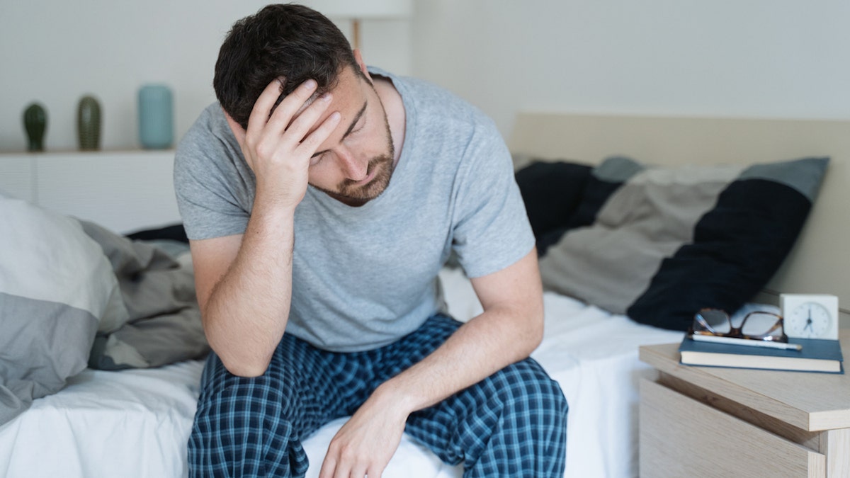 Man sitting on bed