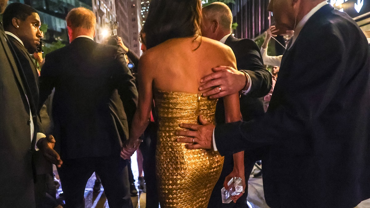 Meghan Markle assisted through crowded walkway to waiting vehicle after awards ceremony